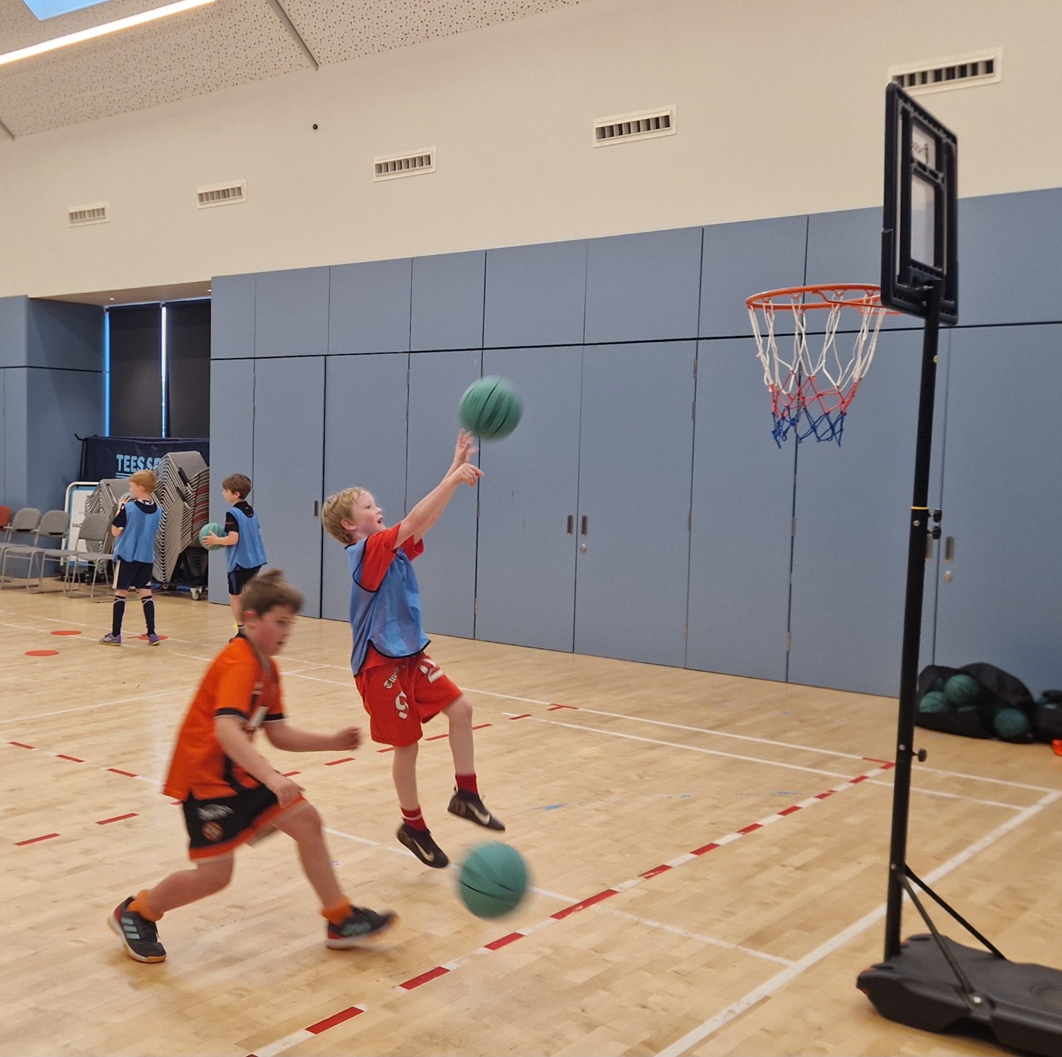 Young basketball player finishing at a lowered hoop