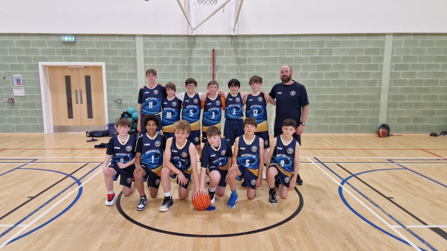 North East Fife Basketball team and Coach Shayne together on court