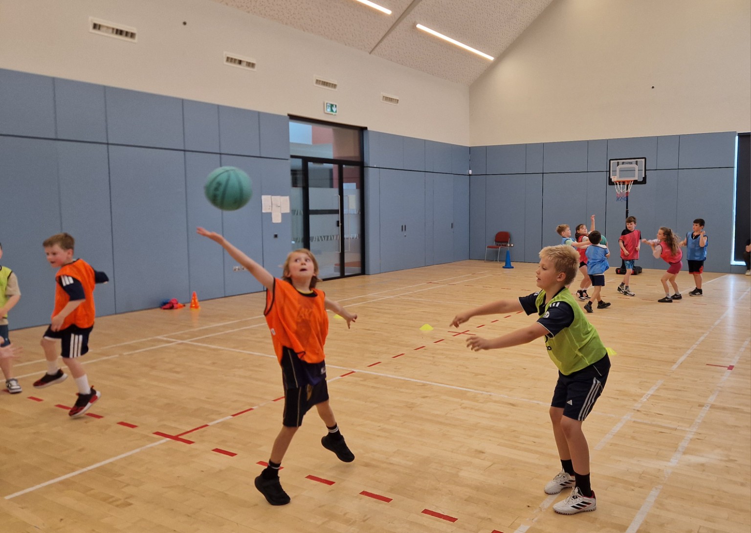 Young players passing and moving during a basketball game