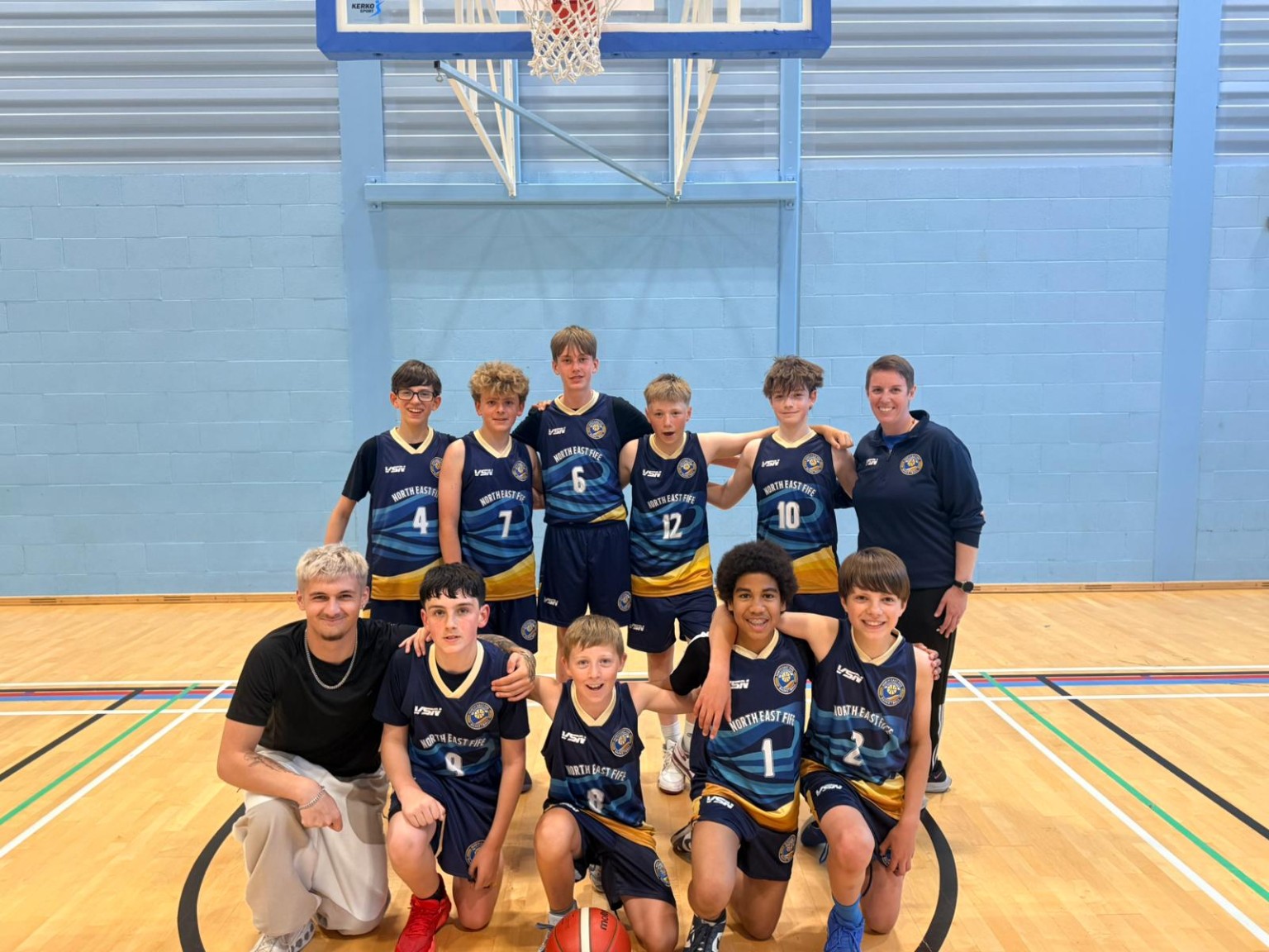 North East Fife Basketball players and coaches posing together after a game