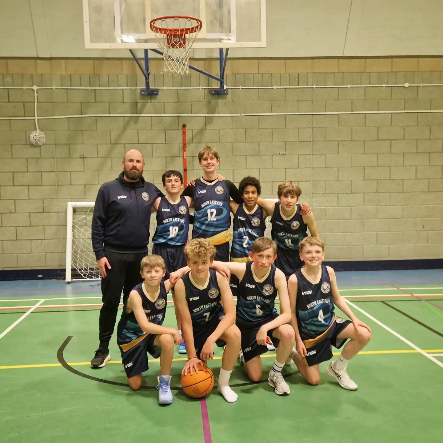 The eight NEF Under-14 players and Coach Shayne together after the friendly against Fife Steel